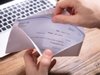 hand removing a paycheck from an envelope