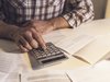 Man using a calculator for finances