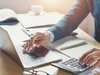 Businessman with a calculator and laptop