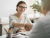 woman shaking hands and getting hired