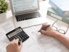 Accountant working with a laptop and a calculator