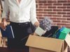 businesswoman holding a packed box full of office things